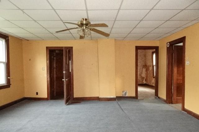 426 Pottawatomie St, Leavenworth, KS 66048 - carpeted empty room with ceiling fan, a paneled ceiling, and healthy amount of natural light
