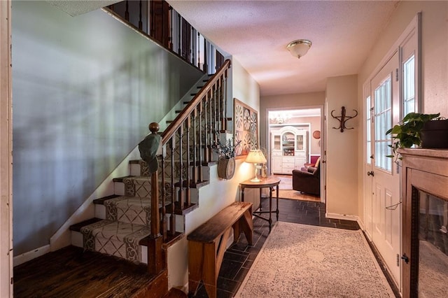 25421 Marel Rd, Excelsior Springs, MO 64024 - stairs featuring stone tile floors and a textured ceiling