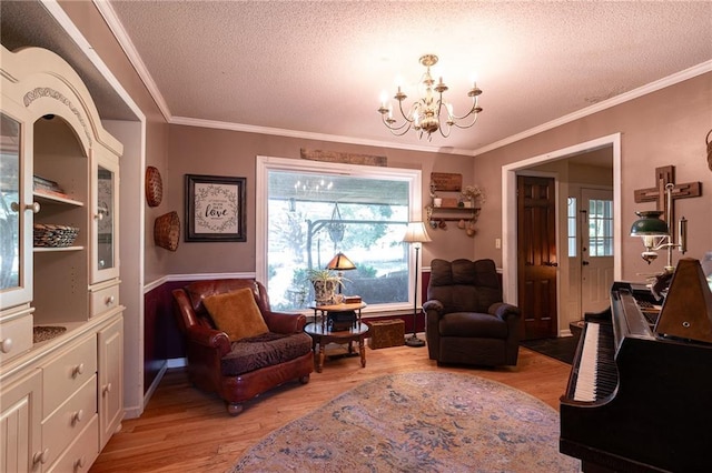 25421 Marel Rd, Excelsior Springs, MO 64024 - sitting room featuring a textured ceiling, light wood-type flooring, a chandelier, and crown molding