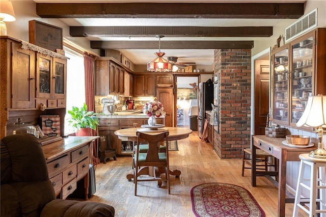 25421 Marel Rd, Excelsior Springs, MO 64024 - dining area with light wood-style flooring, ceiling fan, and beamed ceiling