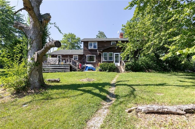 25421 Marel Rd, Excelsior Springs, MO 64024 - rear view of property with a chimney, a deck, and a lawn
