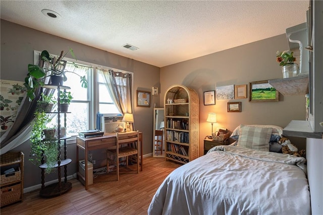 25421 Marel Rd, Excelsior Springs, MO 64024 - bedroom with wood finished floors, a textured ceiling, and a desk