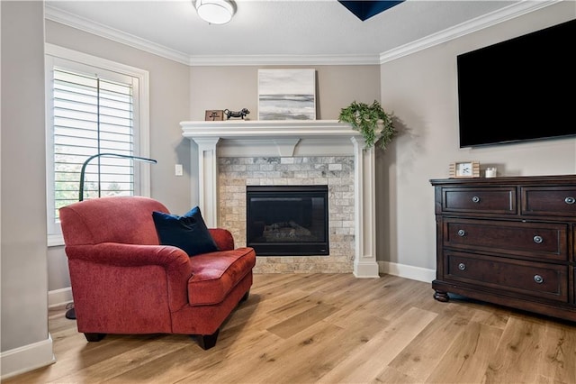16420 Lucille St, Overland Park, KS 66221 - living room featuring ornamental molding, light wood-type flooring, and a glass covered fireplace