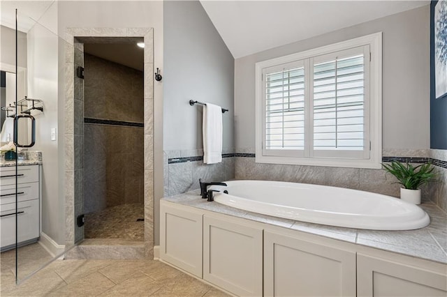16420 Lucille St, Overland Park, KS 66221 - full bathroom featuring a stall shower, a bath, lofted ceiling, vanity, and tile patterned flooring