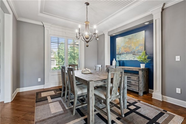 16420 Lucille St, Overland Park, KS 66221 - dining room featuring ornate columns, dark wood-style flooring, a chandelier, ornamental molding, and a raised ceiling