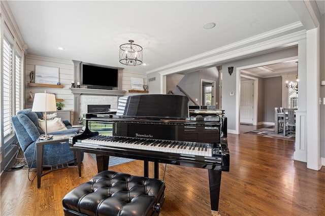 16420 Lucille St, Overland Park, KS 66221 - sitting room featuring a chandelier, ornamental molding, a glass covered fireplace, wood finished floors, and recessed lighting