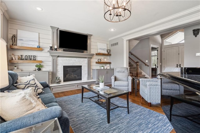 16420 Lucille St, Overland Park, KS 66221 - living area featuring stairway, crown molding, a chandelier, recessed lighting, and a glass covered fireplace