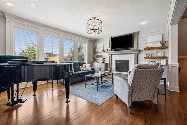 16420 Lucille St, Overland Park, KS 66221 - living area with dark wood finished floors, a fireplace, a chandelier, and recessed lighting