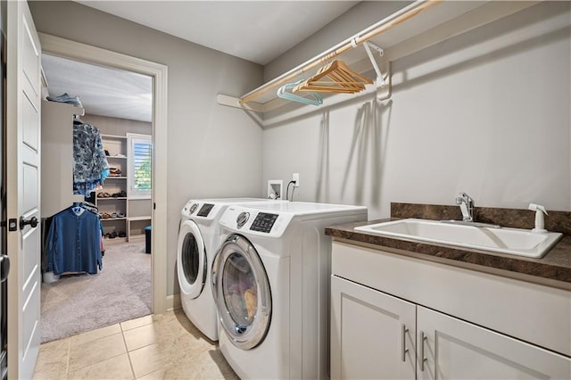 16420 Lucille St, Overland Park, KS 66221 - laundry room with washing machine and dryer, light colored carpet, cabinet space, and light tile patterned floors
