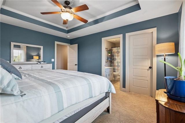 16420 Lucille St, Overland Park, KS 66221 - carpeted bedroom featuring a tray ceiling, ornamental molding, ensuite bath, and ceiling fan