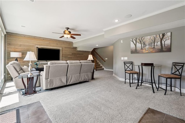 16420 Lucille St, Overland Park, KS 66221 - living room featuring wood walls, a ceiling fan, stairs, carpet flooring, and crown molding