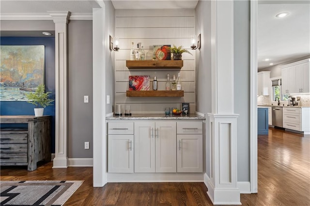 16420 Lucille St, Overland Park, KS 66221 - indoor bar featuring stainless steel dishwasher, dark wood-type flooring, ornate columns, ornamental molding, and recessed lighting