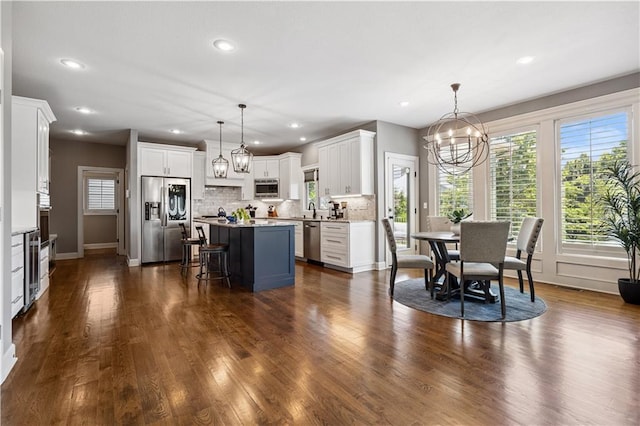 16420 Lucille St, Overland Park, KS 66221 - kitchen with stainless steel appliances, a chandelier, a kitchen island, healthy amount of natural light, and recessed lighting