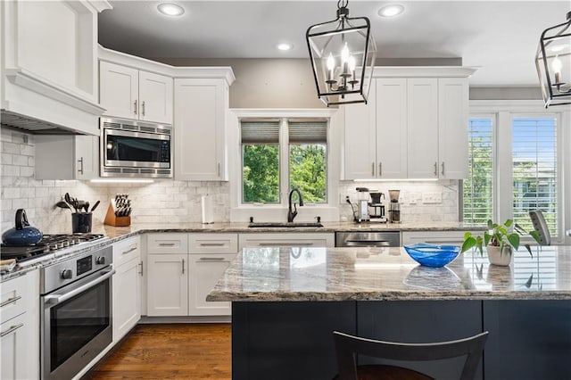 16420 Lucille St, Overland Park, KS 66221 - kitchen with appliances with stainless steel finishes, plenty of natural light, a chandelier, recessed lighting, and white cabinets