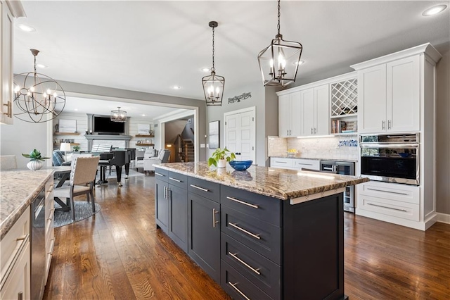 16420 Lucille St, Overland Park, KS 66221 - kitchen with appliances with stainless steel finishes, a chandelier, beverage cooler, white cabinetry, and recessed lighting