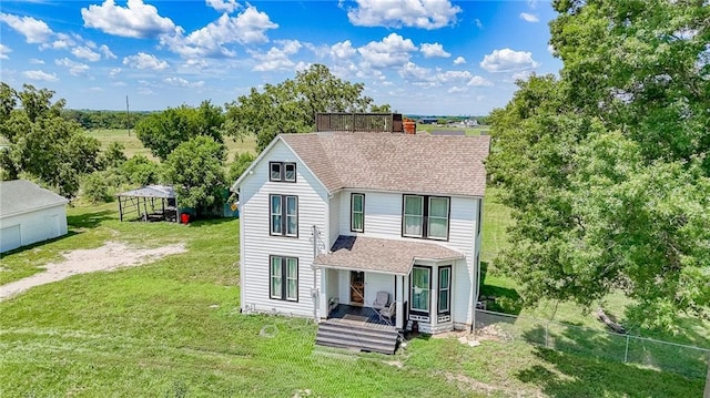 600 W Chestnut St, Holden, MO 64040 - view of front of property with roof with shingles, a chimney, and view of wooded area
