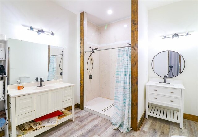 600 W Chestnut St, Holden, MO 64040 - bathroom with wood finished floors, a stall shower, and vanity