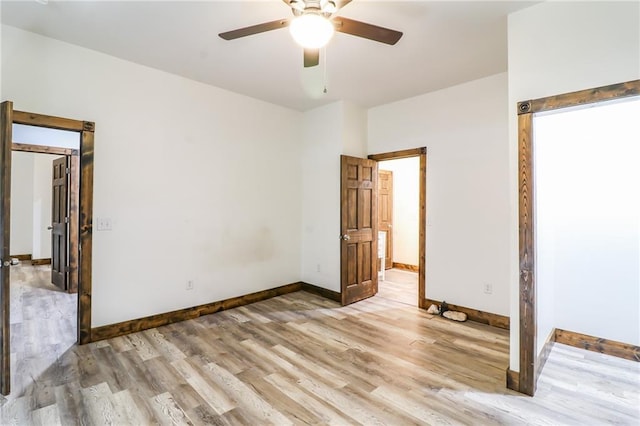 600 W Chestnut St, Holden, MO 64040 - unfurnished bedroom featuring light wood finished floors and a ceiling fan