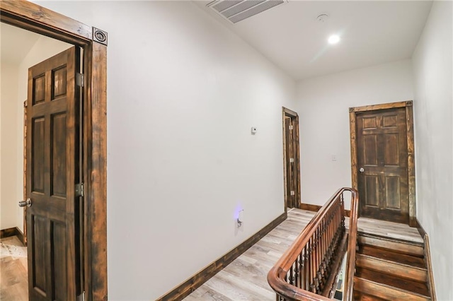 600 W Chestnut St, Holden, MO 64040 - corridor featuring light wood-style flooring and an upstairs landing