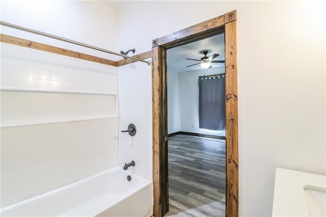 600 W Chestnut St, Holden, MO 64040 - full bath with shower / washtub combination, wood finished floors, ceiling fan, and vanity