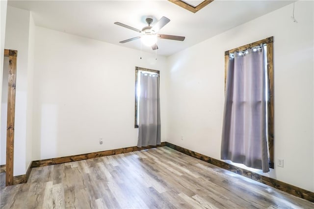 600 W Chestnut St, Holden, MO 64040 - empty room with wood finished floors and ceiling fan