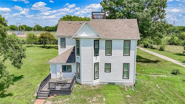600 W Chestnut St, Holden, MO 64040 - rear view of house with a shingled roof, a lawn, and a deck