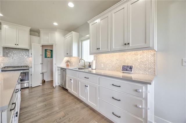 24976 W 87th St, Lenexa, KS 66227 - kitchen featuring appliances with stainless steel finishes, white cabinets, light countertops, recessed lighting, and light wood-type flooring