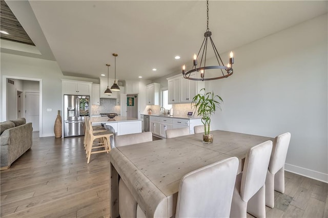 24976 W 87th St, Lenexa, KS 66227 - dining space with a chandelier, recessed lighting, and light wood-style floors