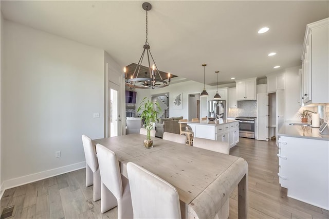 24976 W 87th St, Lenexa, KS 66227 - dining space with a chandelier, recessed lighting, and wood finished floors