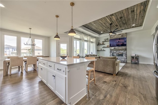 24976 W 87th St, Lenexa, KS 66227 - kitchen featuring healthy amount of natural light, a raised ceiling, white cabinets, dark wood-type flooring, and wood ceiling