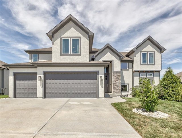 24976 W 87th St, Lenexa, KS 66227 - view of front facade with stucco siding, driveway, and a garage