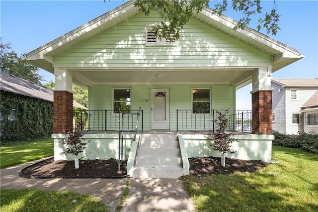 1962 N 28th St, Kansas City, KS 66104 - shotgun-style home featuring covered porch and a front lawn