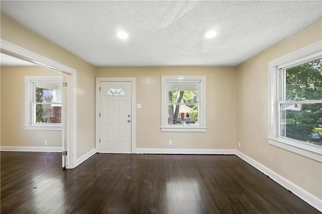 1962 N 28th St, Kansas City, KS 66104 - entrance foyer featuring plenty of natural light, dark wood-type flooring, a textured ceiling, and recessed lighting