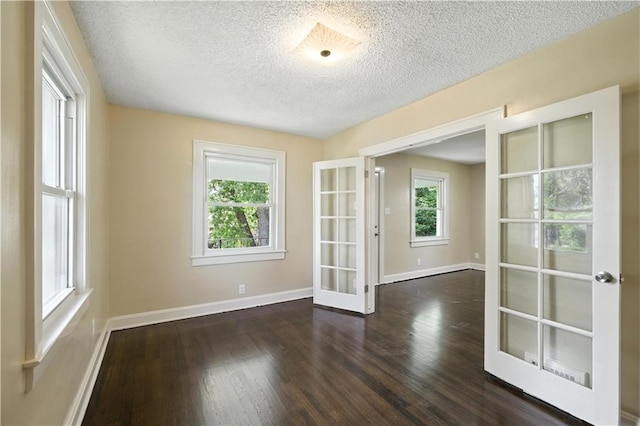 1962 N 28th St, Kansas City, KS 66104 - spare room featuring french doors, a textured ceiling, and wood finished floors