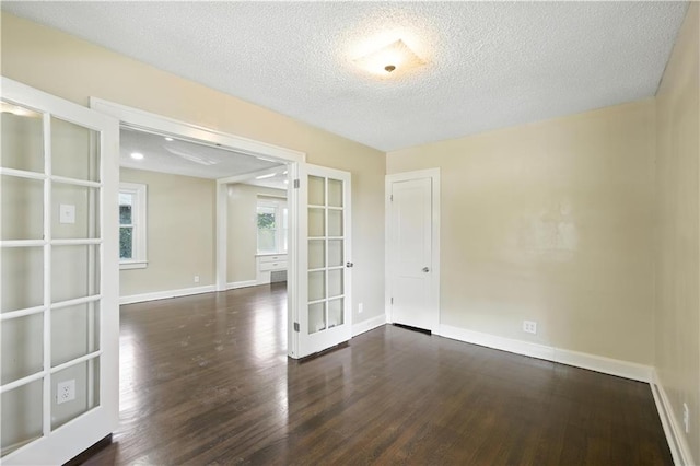 1962 N 28th St, Kansas City, KS 66104 - empty room with french doors, wood finished floors, and a textured ceiling
