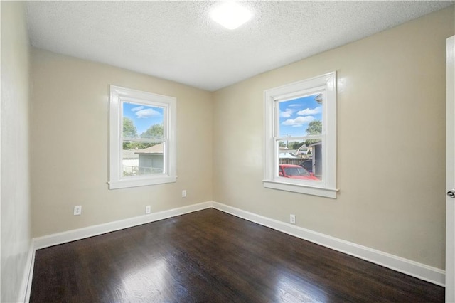 1962 N 28th St, Kansas City, KS 66104 - spare room featuring dark wood-type flooring and a textured ceiling