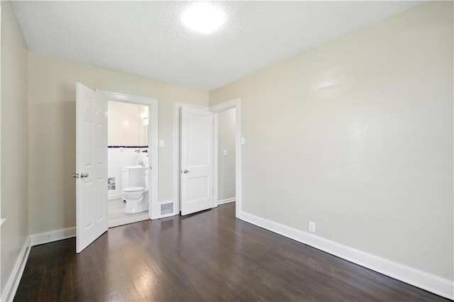 1962 N 28th St, Kansas City, KS 66104 - unfurnished bedroom featuring wood finished floors and ensuite bath