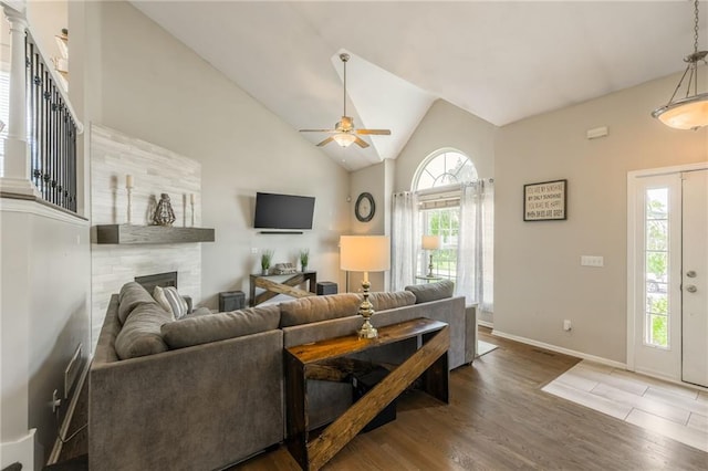 8103 NE 111th Ter, Kansas City, MO 64157 - living room featuring a ceiling fan, wood finished floors, a tiled fireplace, and lofted ceiling