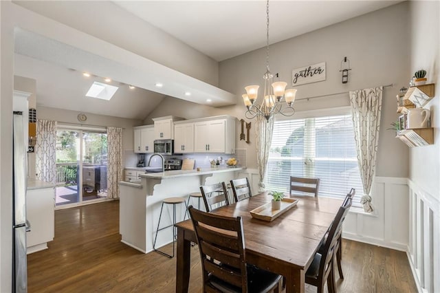 8103 NE 111th Ter, Kansas City, MO 64157 - dining area featuring dark wood-type flooring, vaulted ceiling, a chandelier, recessed lighting, and a skylight