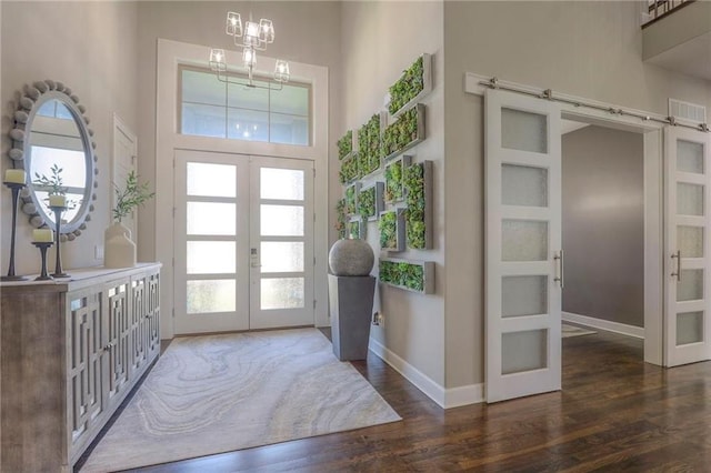 15716 Canterbury St, Overland Park, KS 66085 - entrance foyer with french doors, healthy amount of natural light, wood finished floors, a towering ceiling, and a chandelier