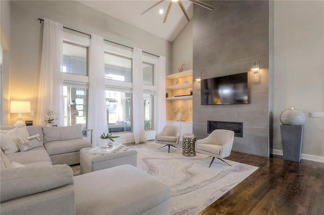 15716 Canterbury St, Overland Park, KS 66085 - living room featuring high vaulted ceiling, wood finished floors, ceiling fan, and a large fireplace