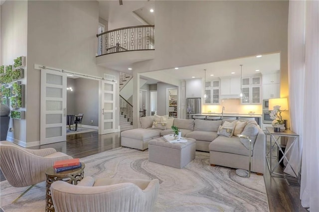 15716 Canterbury St, Overland Park, KS 66085 - living area featuring a towering ceiling, wood finished floors, and stairway