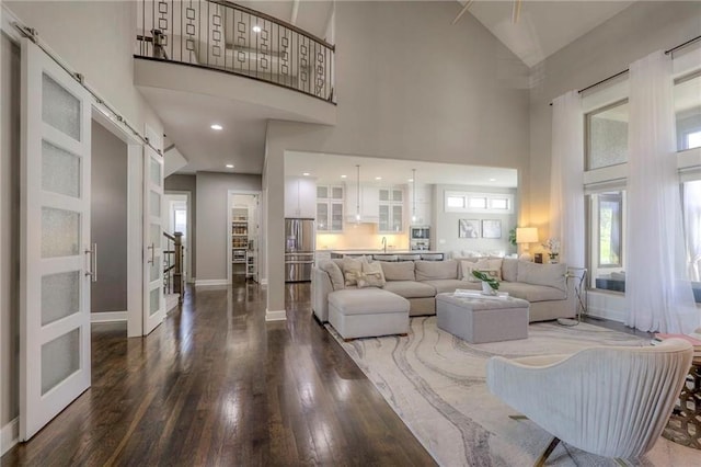 15716 Canterbury St, Overland Park, KS 66085 - living area featuring a high ceiling, wood finished floors, plenty of natural light, and french doors