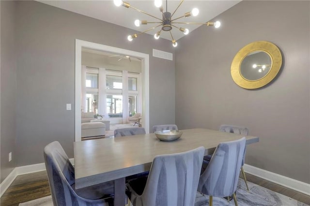 15716 Canterbury St, Overland Park, KS 66085 - dining room with wood finished floors and a chandelier