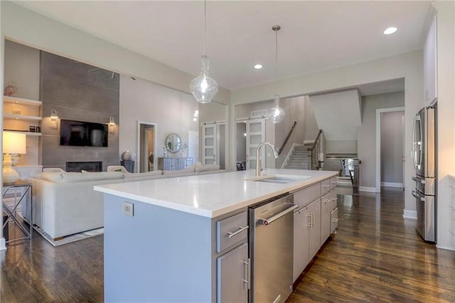 15716 Canterbury St, Overland Park, KS 66085 - kitchen with appliances with stainless steel finishes, dark wood-style floors, open floor plan, and recessed lighting