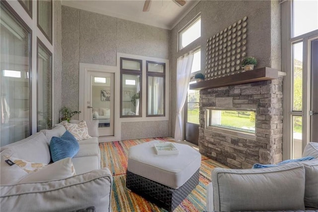 15716 Canterbury St, Overland Park, KS 66085 - living room with a stone fireplace, a ceiling fan, and a high ceiling