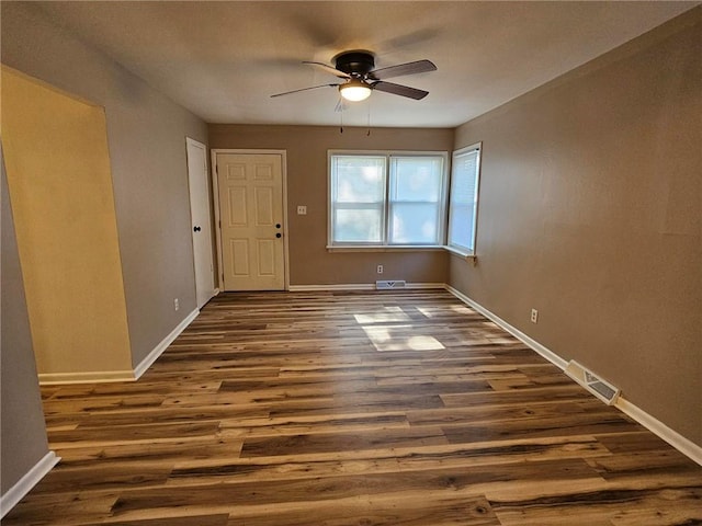 1615 N High St, Independence, MO 64050 - unfurnished room with ceiling fan and dark wood-style flooring