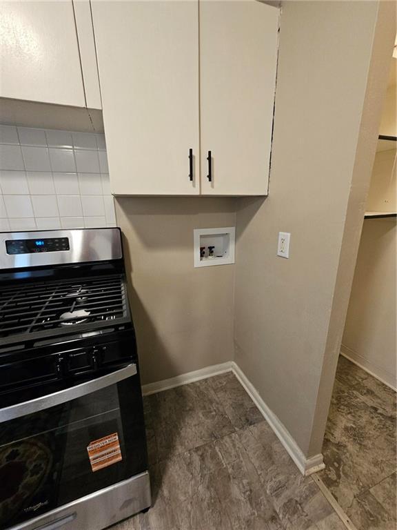 1615 N High St, Independence, MO 64050 - washroom with baseboards and washer hookup