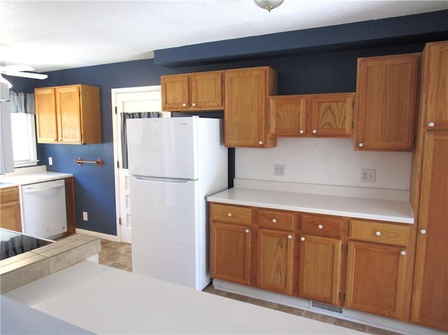502 N Jefferson St, Spring Hill, KS 66083 - kitchen featuring white appliances, brown cabinets, light countertops, and a ceiling fan