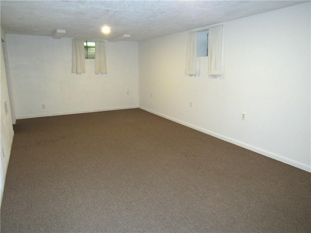 502 N Jefferson St, Spring Hill, KS 66083 - finished below grade area with dark colored carpet and a textured ceiling